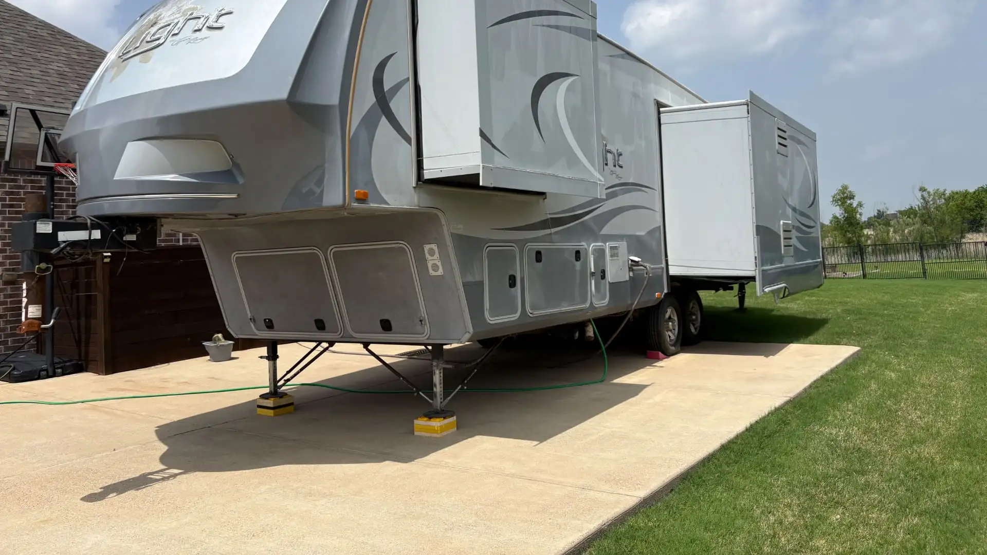 RV consignment lot on I-30 in Greenville, Texas — rows of fifth wheels, toy haulers and travel trailers